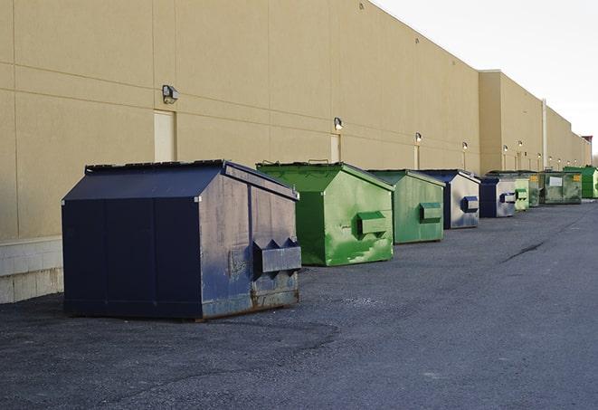 construction workers toss wood scraps into a dumpster in Luckey, OH